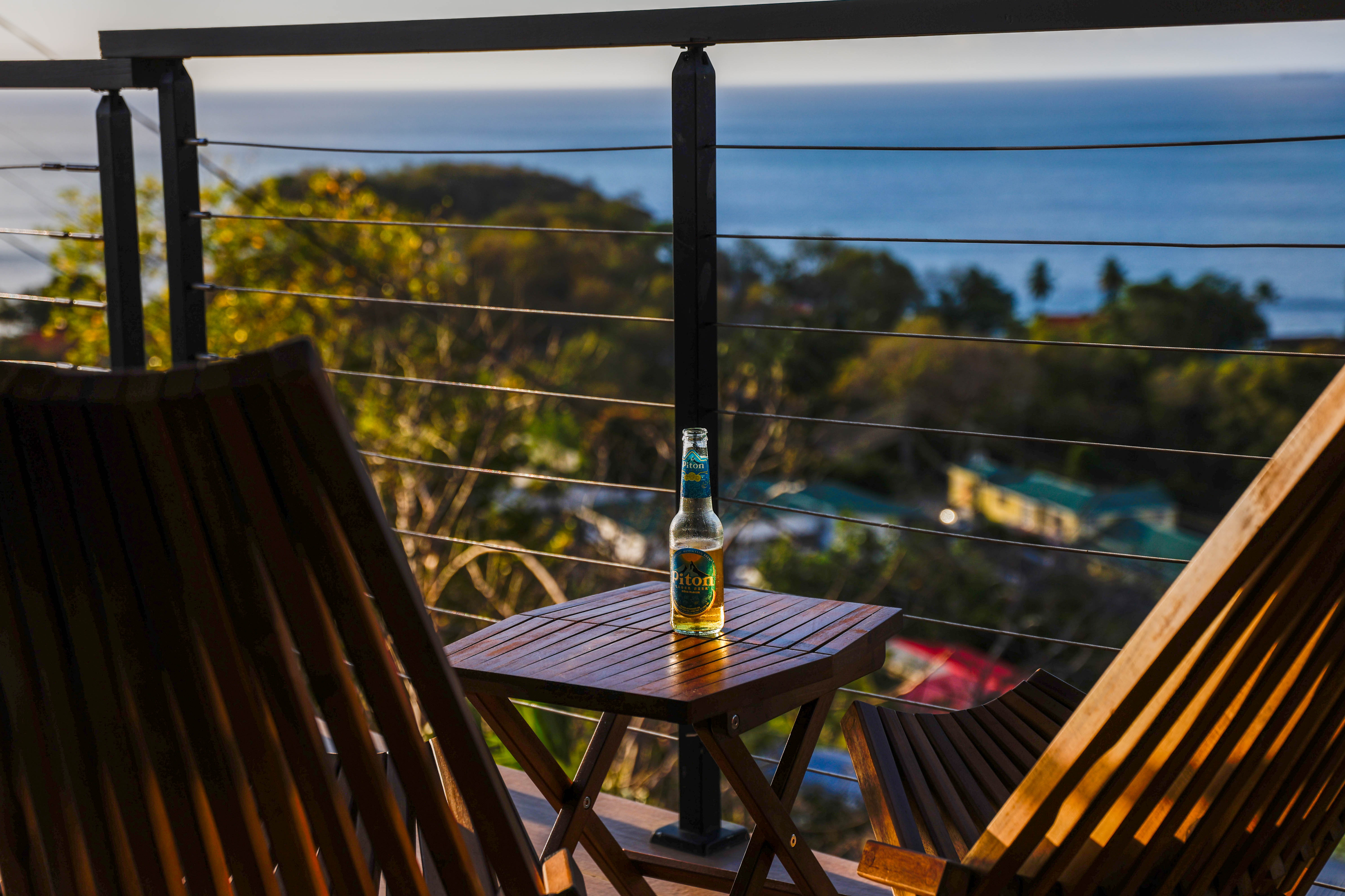 Private balcony at Serene Sunset Escapes Saint Lucia with sea view and teak chairs