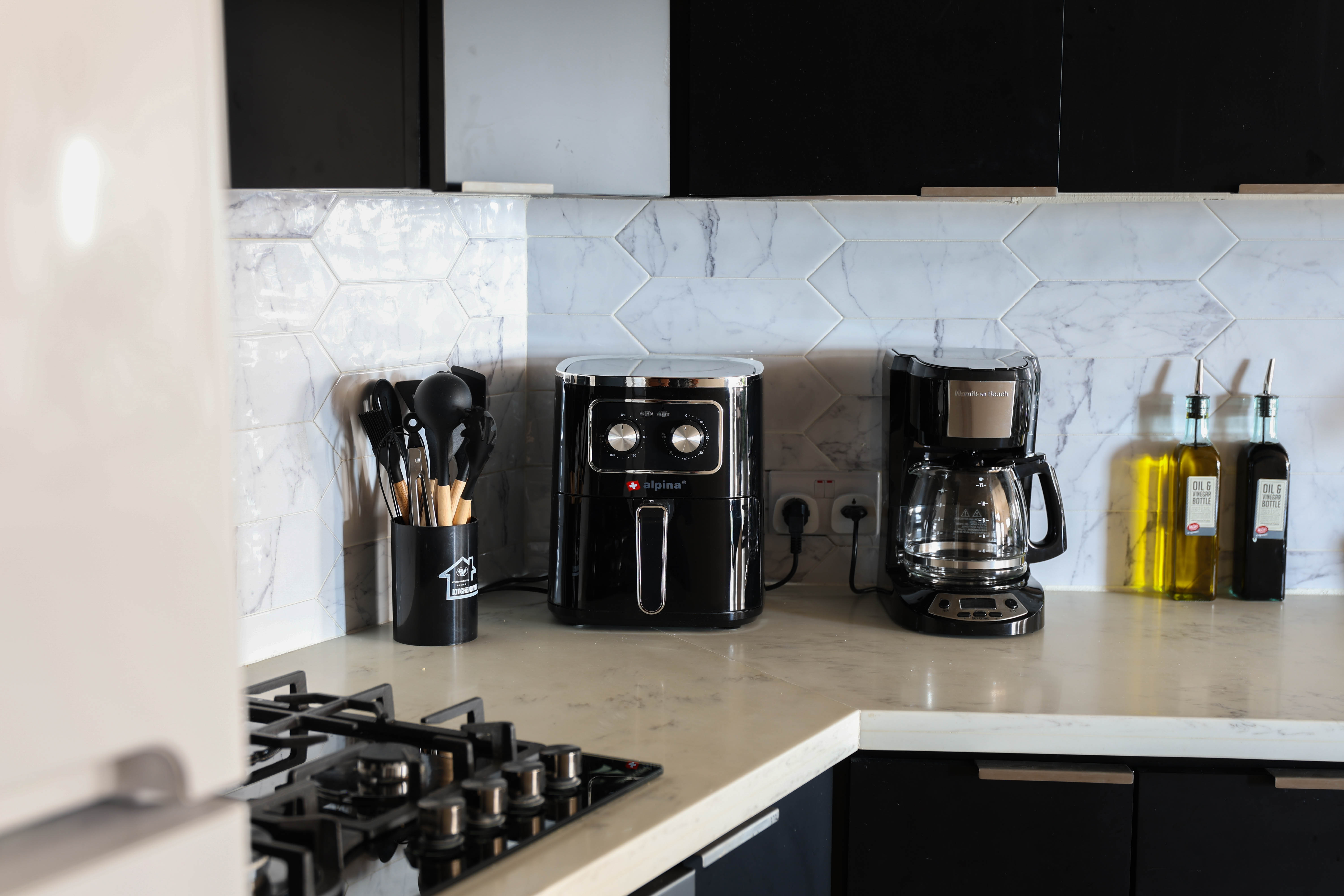 Kitchen appliances at Serene Sunset Escapes Saint Lucia — air fryer, coffee maker, gas hob