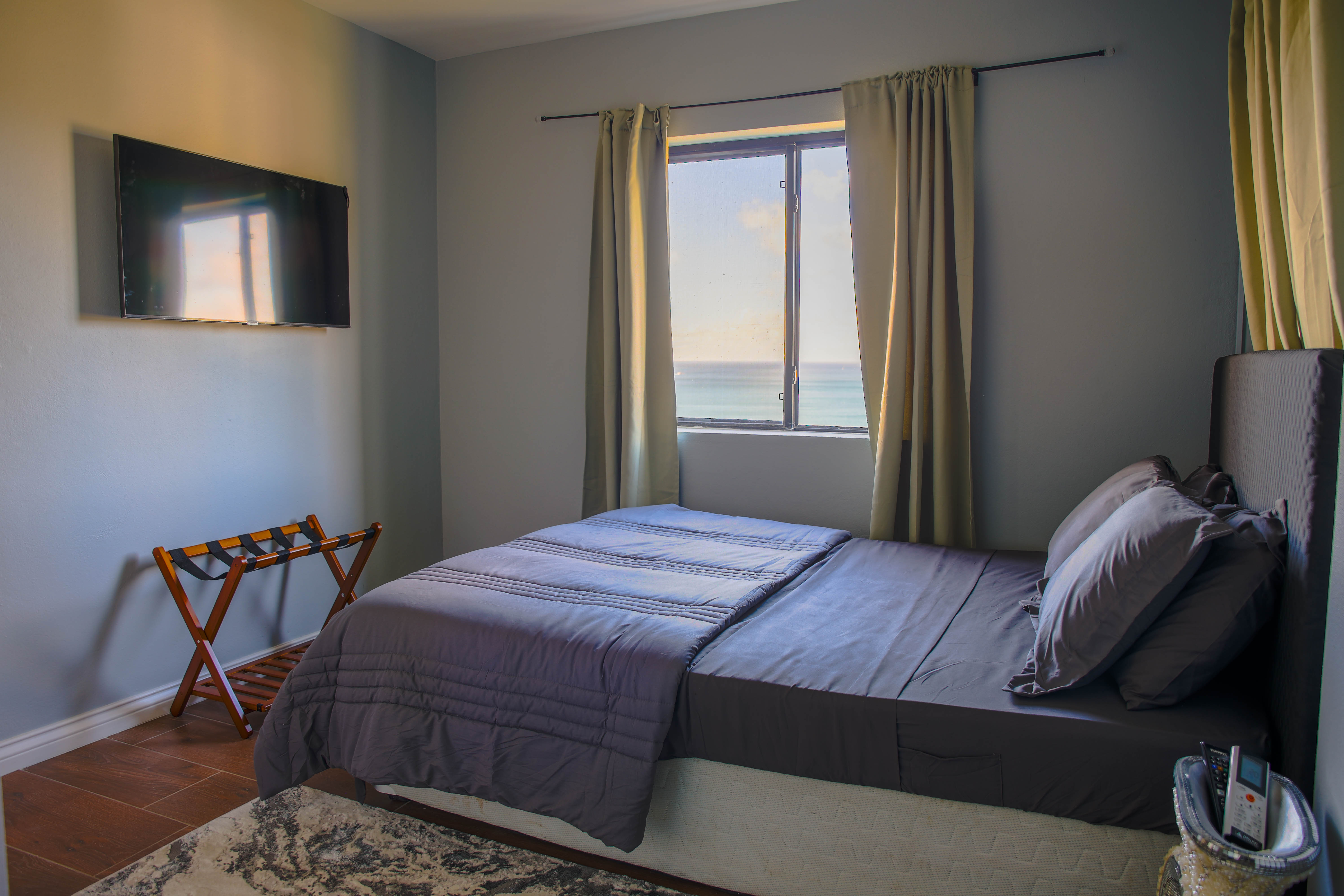 Master bedroom at Serene Sunset Escapes Saint Lucia — king bed with ocean view window