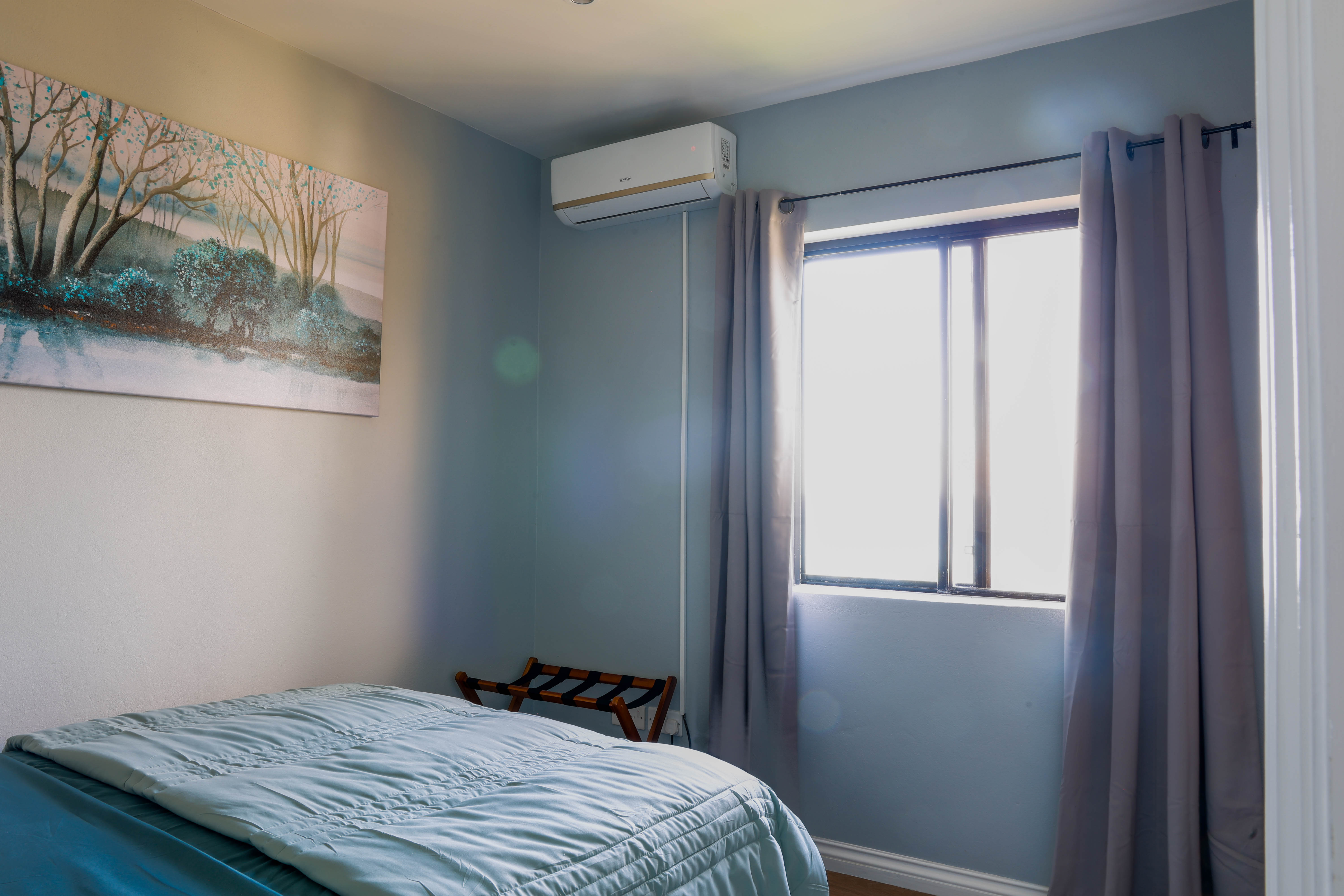 Second bedroom at Serene Sunset Escapes Saint Lucia — queen bed with air conditioning